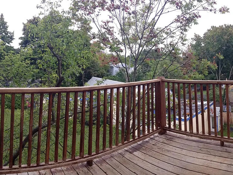 Rear deck facing large yard and trees