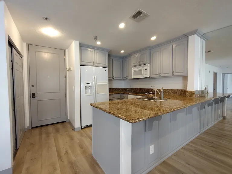 Entry and kitchen with granite counters and all appliances