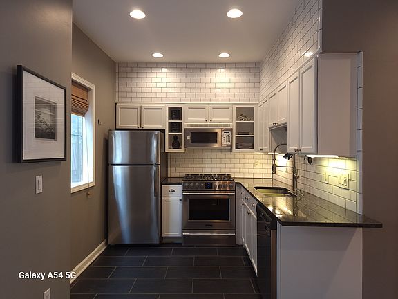 Kitchen features a gas range and new energy-efficient dishwasher and refrigerator.