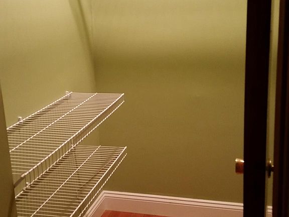 Large hall storage closet with shelves and light