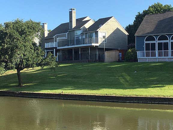 Backside of Home. Proximity to canal is wonderful. You are able to sit under the tree near the canal's edge and picnic.