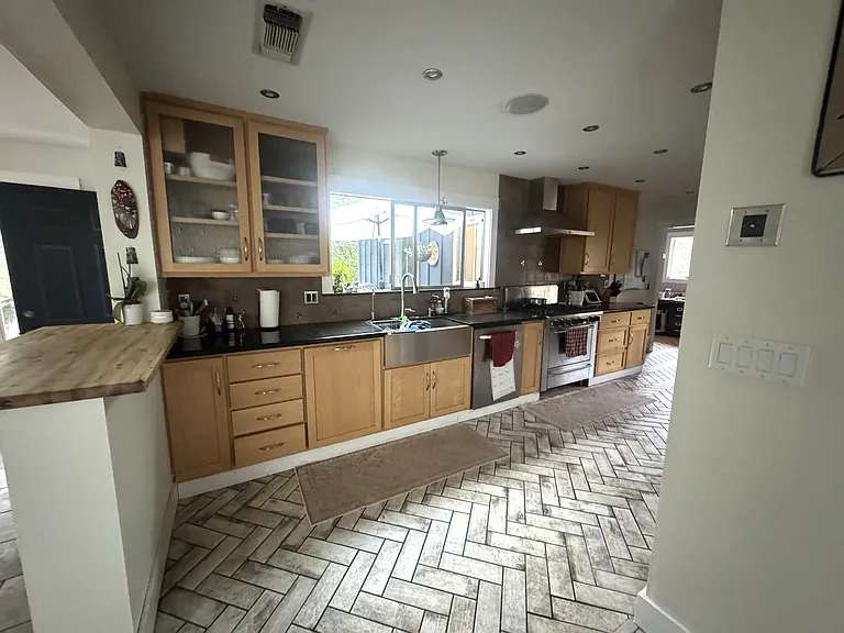 kitchen with dishwasher, microwave and two ovens
