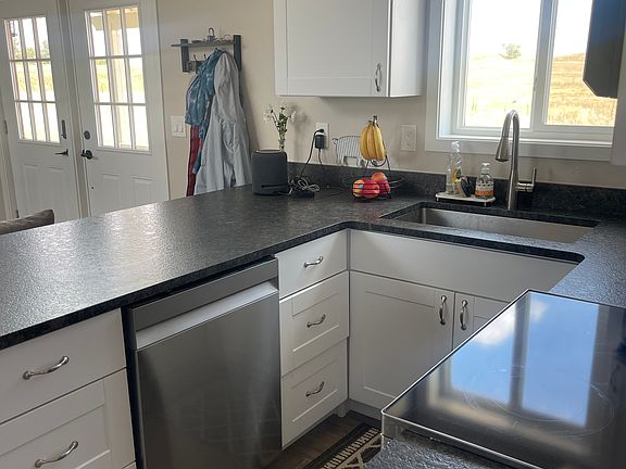 Full kitchen with dishwasher, electric range/oven, and full size built in microwave.