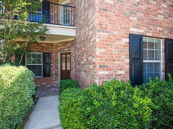 Shutters around the windows.  Covered porch. Walk-out balcony on the second floor from the game room. Beautiful shrubbery leading up to the door way.