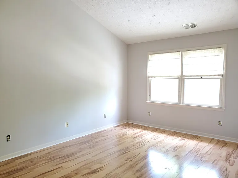 Primary bedroom with vaulted ceiling