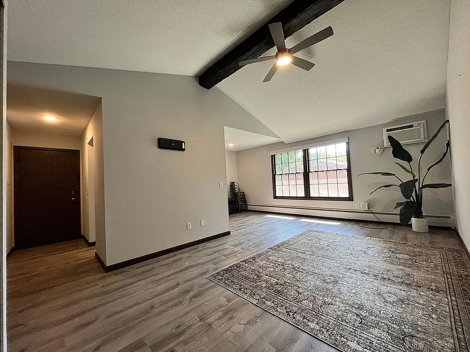 Spacious living room with vaulted ceilings and lots of natural light. One of the only units you will find with a ceiling fan to help circulate air throughout the condo.