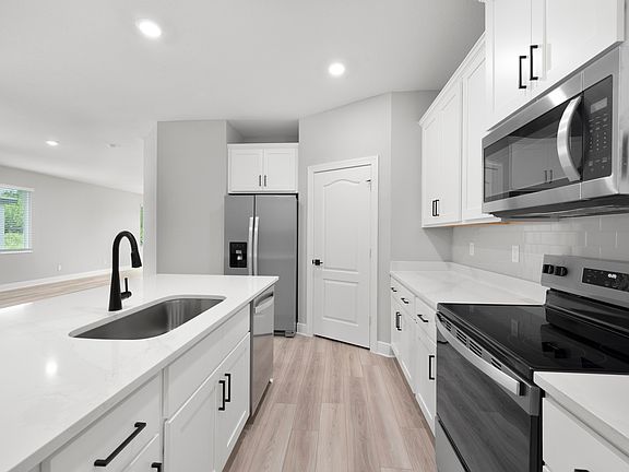 The kitchen is chef-ready with stainless steel appliances