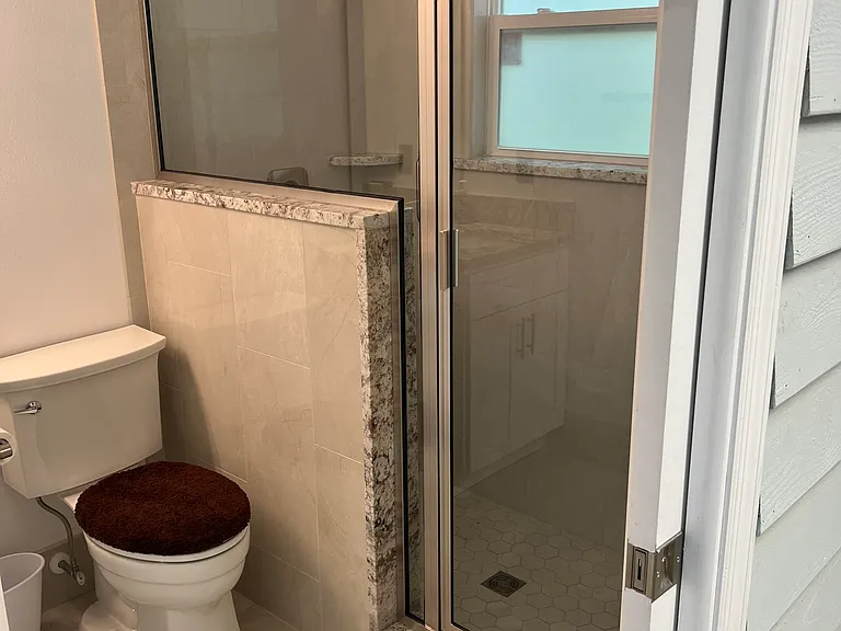 The bathroom is full sized and newly remodeled. There are safety bars, and the window can be opened to allow fresh air. There is also a fan (not shown) in the ceiling.