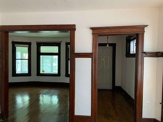 Facing the living room and front entrance from the dining room.