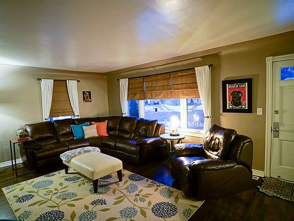 This warm and welcoming living room boasts a tray ceiling and newly re-finshed wood flooring. All of