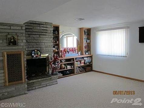 Family room fireplace with gas log.