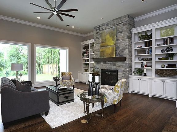 The living area has wood flooring, a gas fireplace, builtin cabinets and shelves and is wired to all