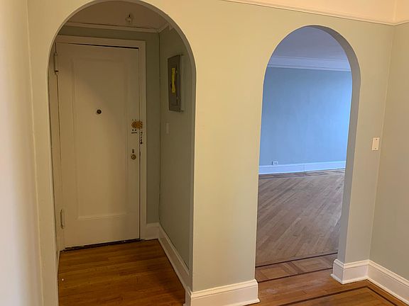 Main entrance, archway to sunny living room