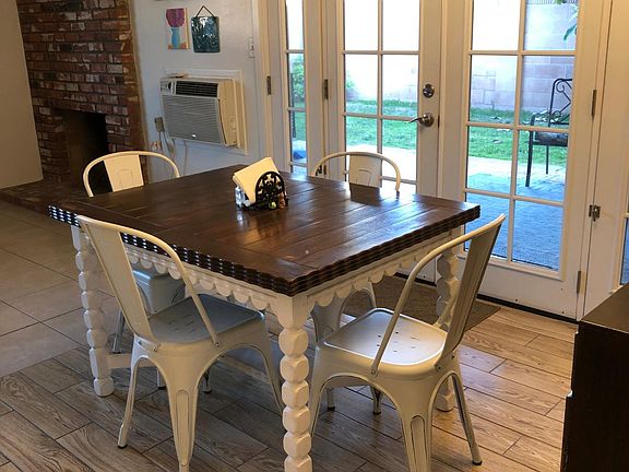 French door opening up to covered patio to grassy sunny backyard fro Dining room area