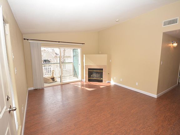 Living room with gas fireplace and access to balcony