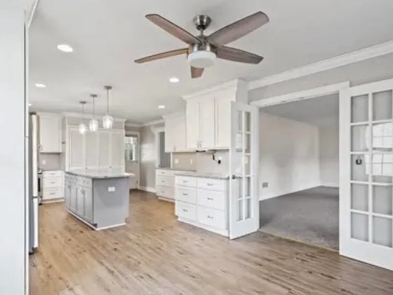 Dining area connected to kitchen with French doors into the living room