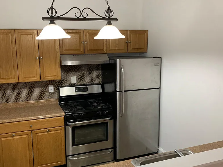 Galley Kitchen with Stainless Steel Appliances.