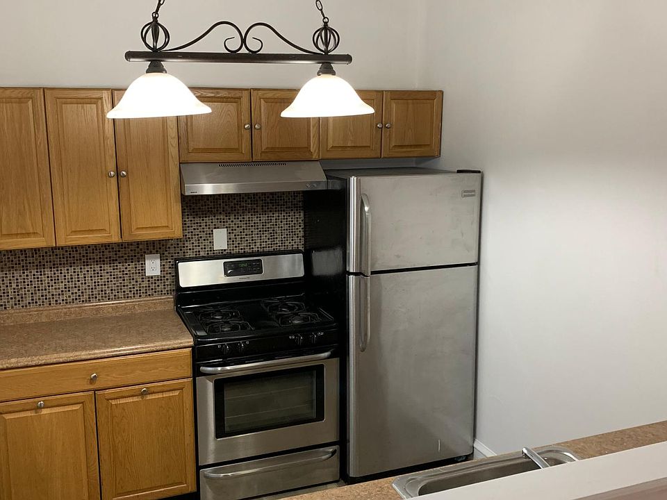 Galley Kitchen with Stainless Steel Appliances.