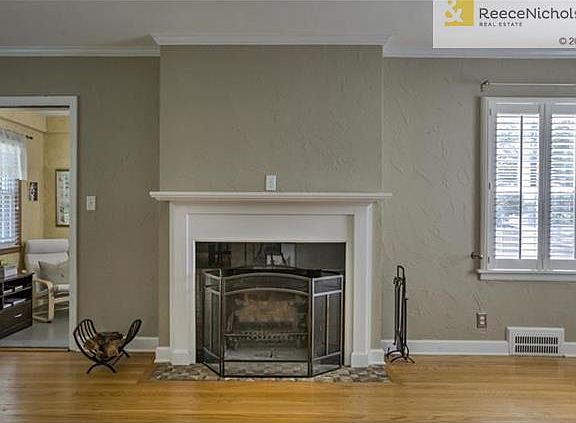 Living room with elegant plantation shutters. Office off the living room~