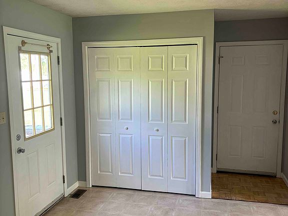 Dining area with utility closet, door to backyard and door to garage.