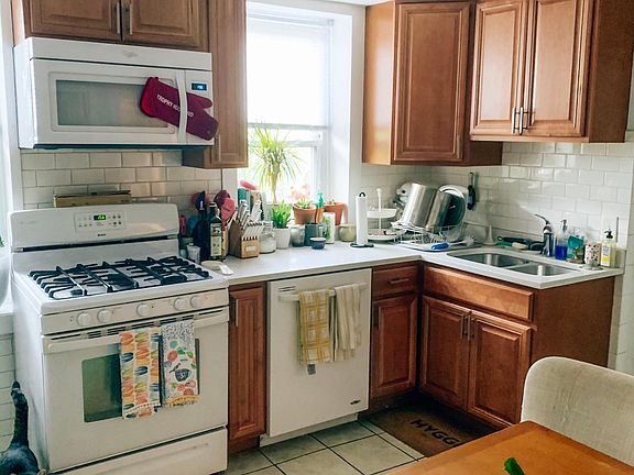 Recently renovated sunny kitchen is fully featured with granite counter top, microwave and dishwasher.