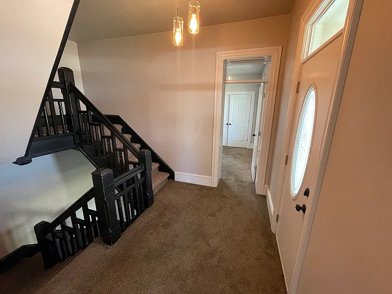 Main landing on second floor. Door to the right leads to second floor porch. The stairs continue up to a locked attic (not accessible).