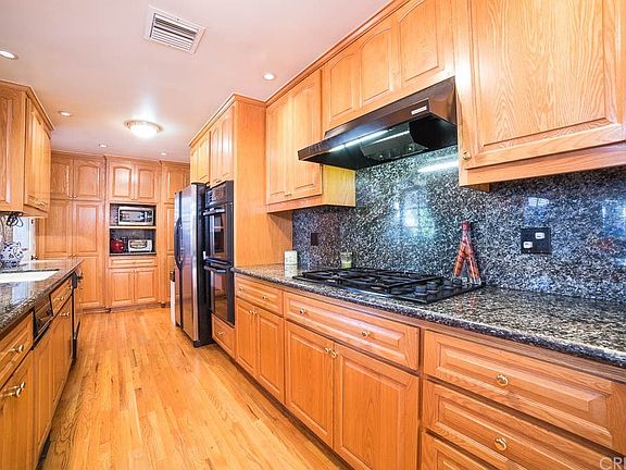 Kitchen with gas range, trash compactor, dishwashe