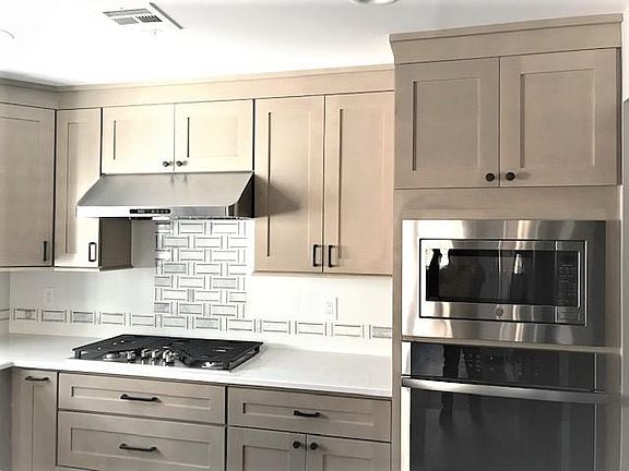 Stainles-steel cooktop, exhaust fan, wall oven, and built-in microwave