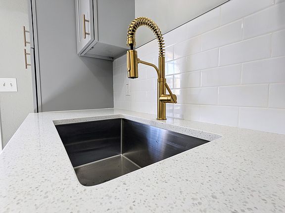 Brand new kitchen sink, granite countertop and subway tile backsplash. No vinyl or other cheap materials used!