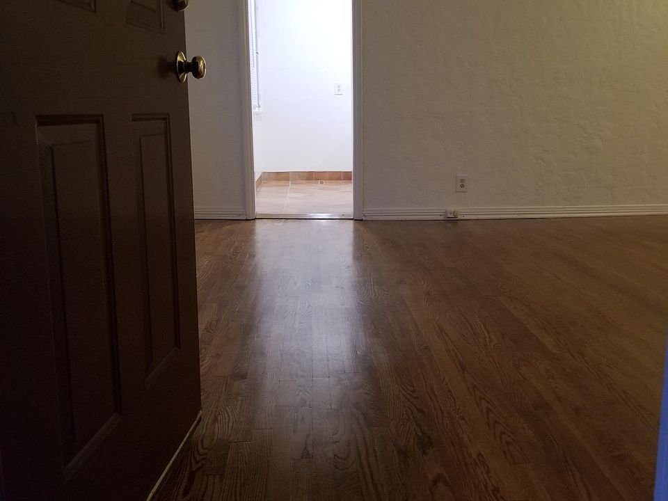 ENTER INTO A HUGE LIVING ROOM WITH HARDWOOD FLOORS
