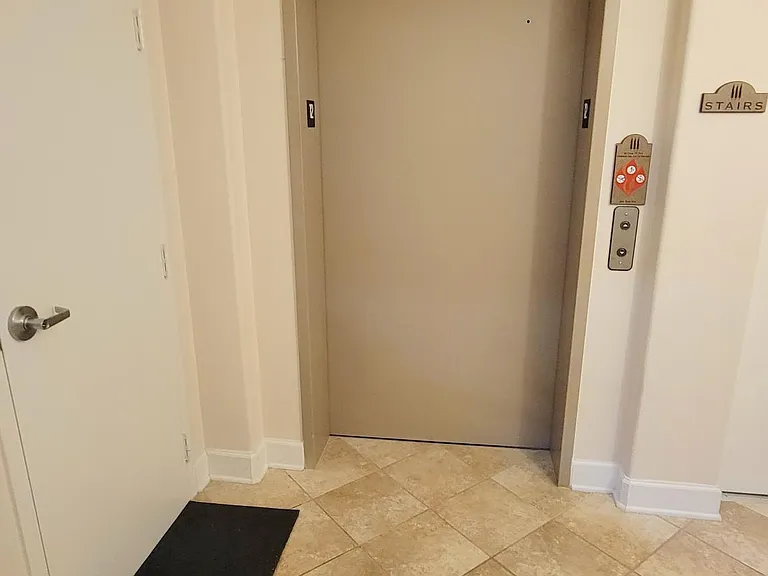 Elevator door and water heater closet door in the unit lobby