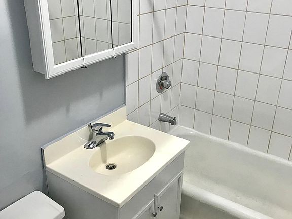 Full bathroom with medicine cabinet for personal storage