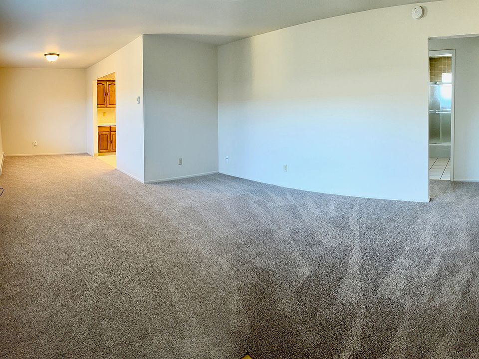 Living Room, facing the dining area and hallway that leads to the bedrooms and bathroom.
