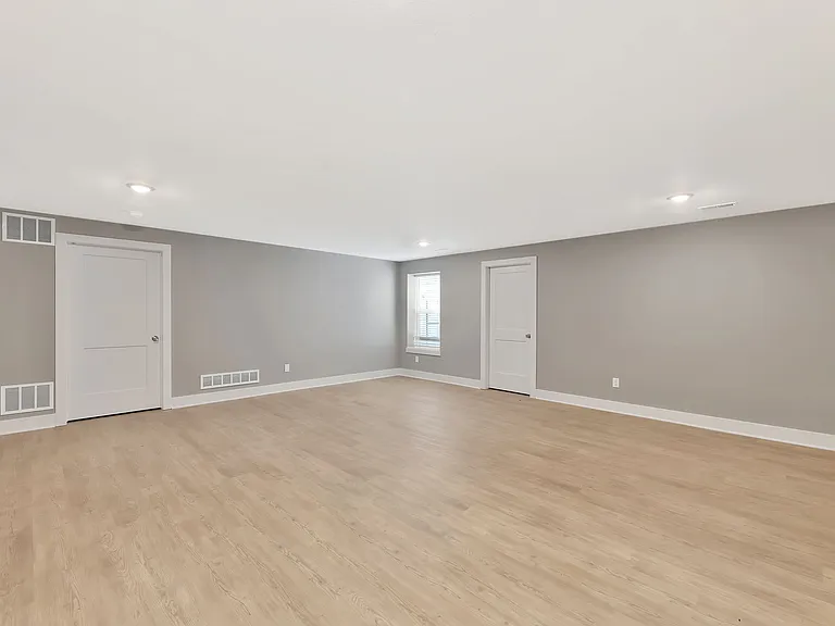 rec room with view out window and unfinished storage area