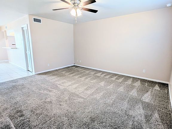 Spacious living room with direct access to the dining and kitchen areas, half bath, and storage closet.