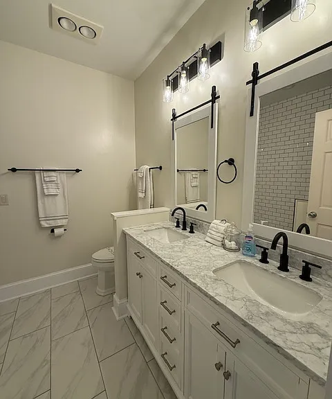 Recently updated primary bath now has 2 sinks and a luxury step in shower with a bench.