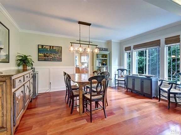 Generous size dining room with modern millwork, updated light fixture and attractive window treatments.