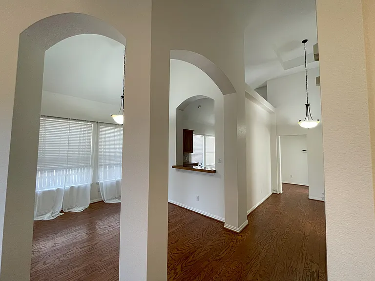 view across dining area towards kitchen and entry hall