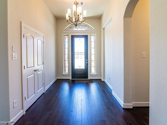 Here is an opposite view looking toward the front door and notice the beautiful chandelier.