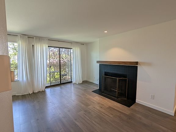 Living room w/fireplace and balcony