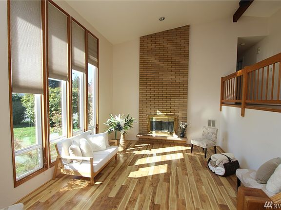 Soaring ceilings w/ floor to ceiling windows and wood burning fireplace. 