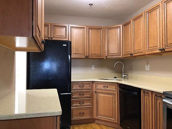 Kitchen view of your model unit with upgraded kitchen cabinetry, quartz counter tops color coordinated high end appliances