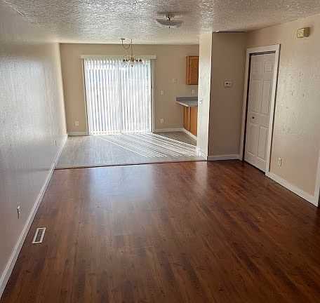 LIVING ROOM AND DINING ROOM WITH SLIDING GLASS DOOR TO BACK PATIO