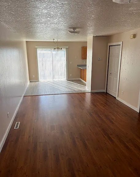 LIVING ROOM AND DINING ROOM WITH SLIDING GLASS DOOR TO BACK PATIO