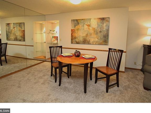 Dining room with lighted bookshelves.