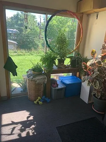 Enclosed front patio area, sliding door faces back yard, garden, and a regular door to the left.
