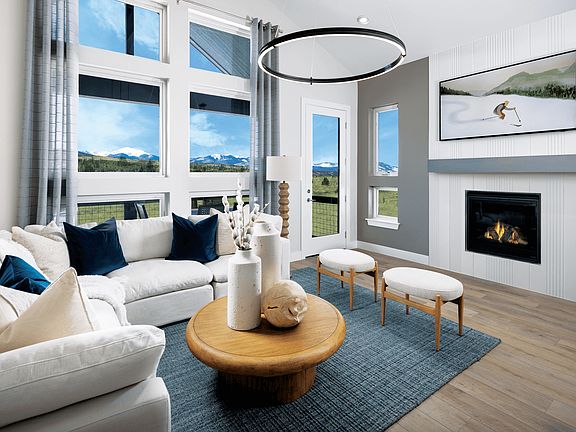The living room features vaulted ceilings that create an open, airy feel and is conveniently located
