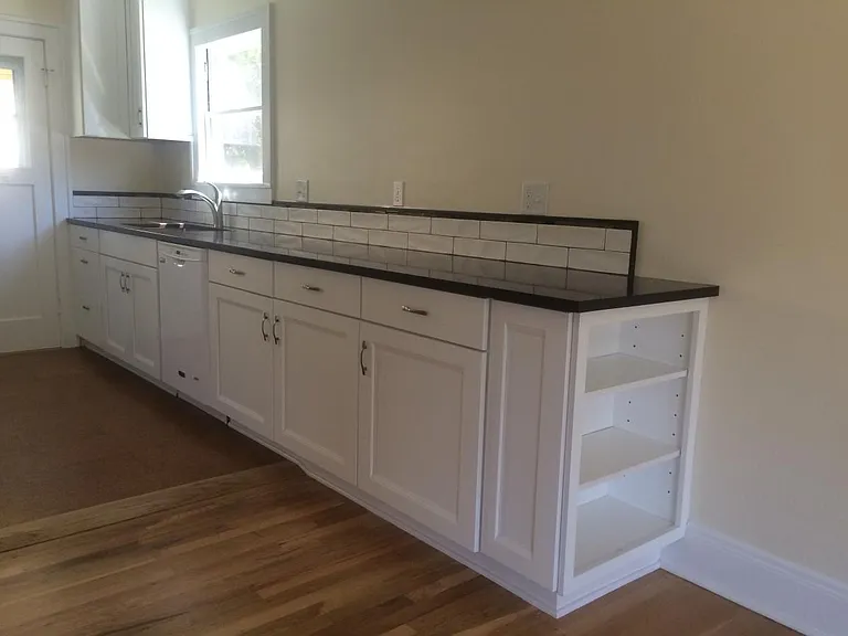 Kitchen flows into living room with built in bookshelf