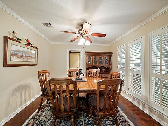 French doors open into the formal dining room with crown molding, double pane windows, shutters and wood floor. The pocket door beyond opens into the study or whatever you want it to be.