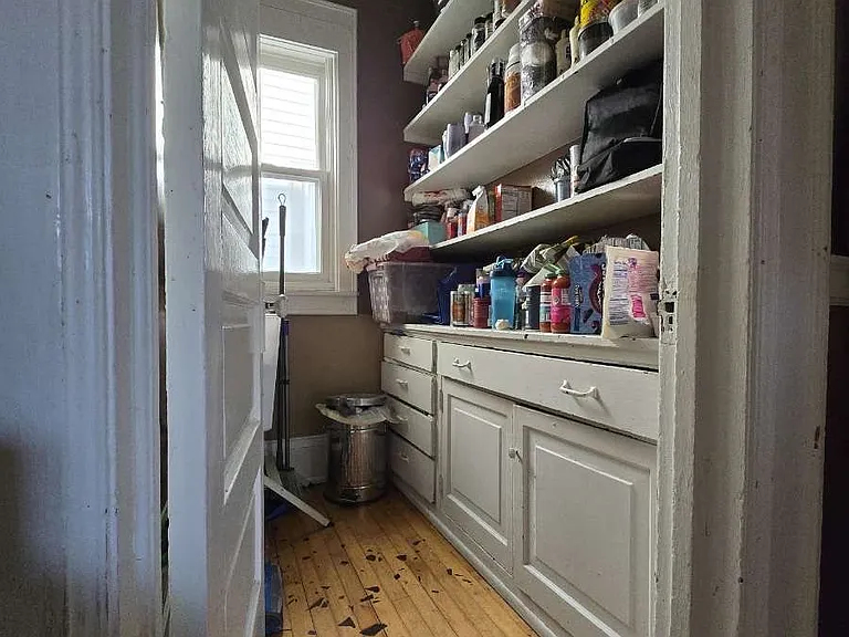 In the kitchen, there is a door to the pantry, handy storage.